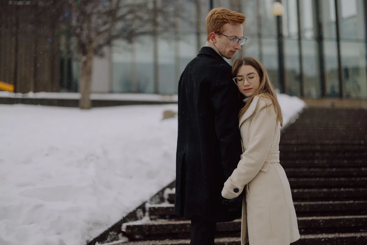 Kaitlyn and Alex during their engagement shoot on the frozen canal