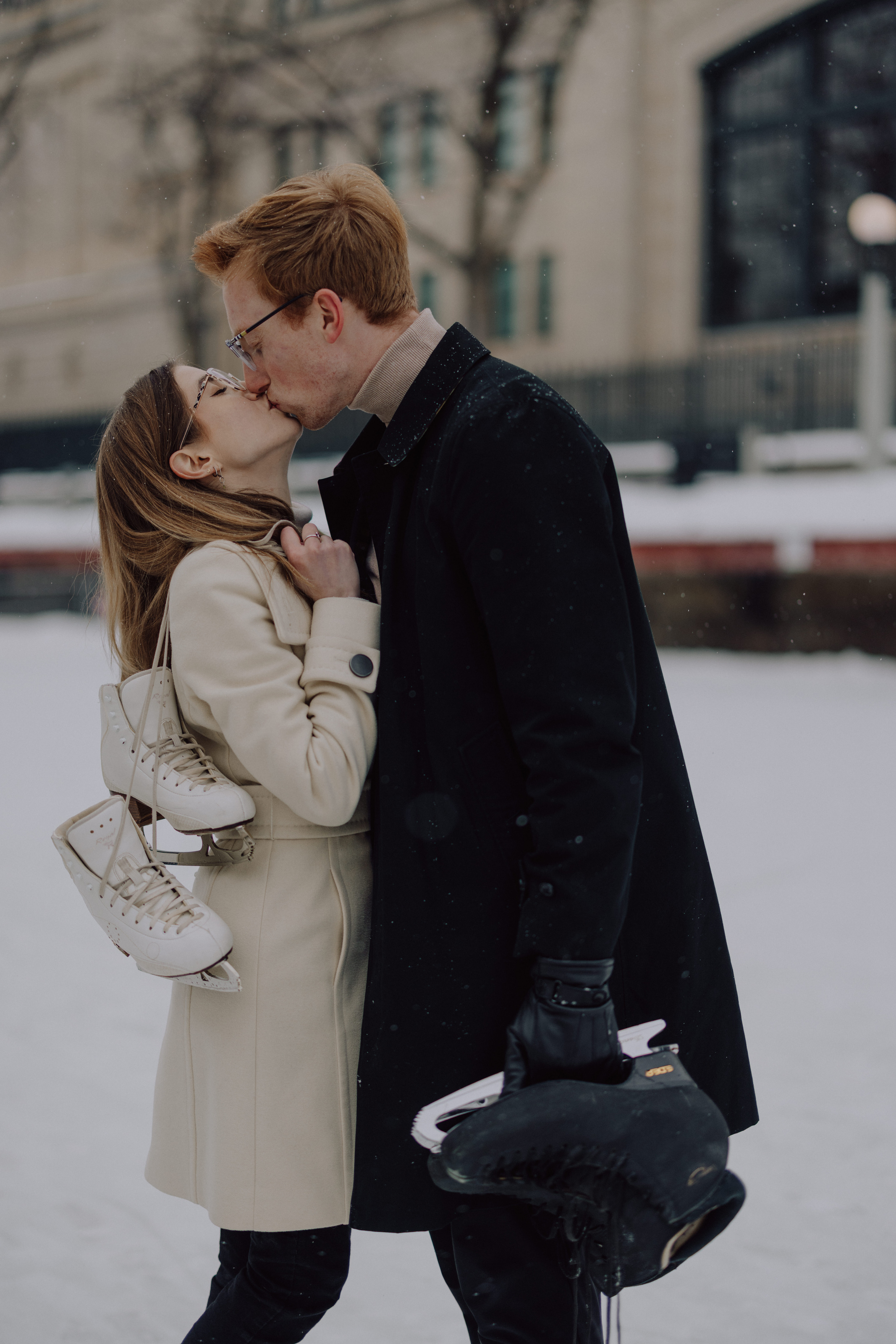Kaitlyn and Alex kissing on the canal, skates in hand