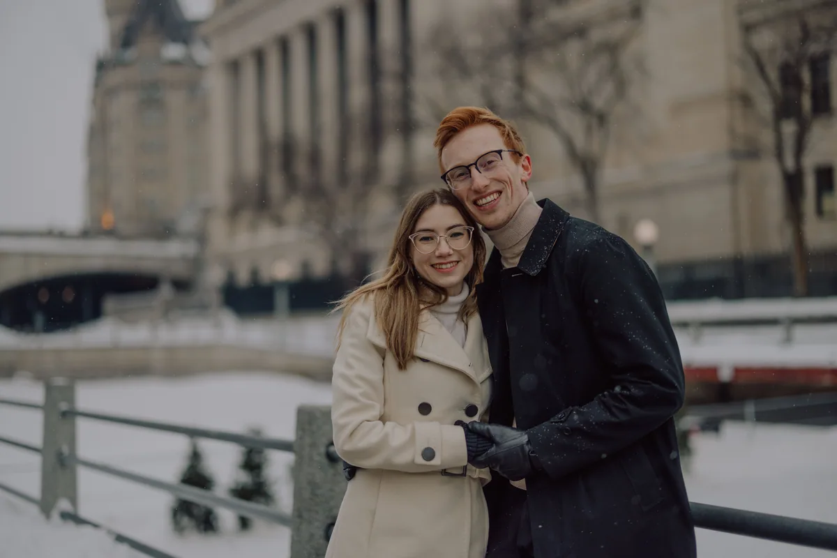 Kaitlyn and Alex during their engagement shoot on the frozen canal