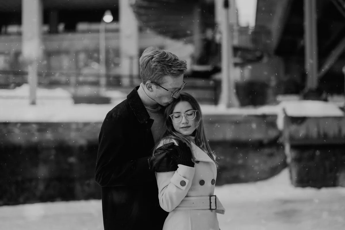 Kaitlyn and Alex during their engagement shoot on the frozen canal