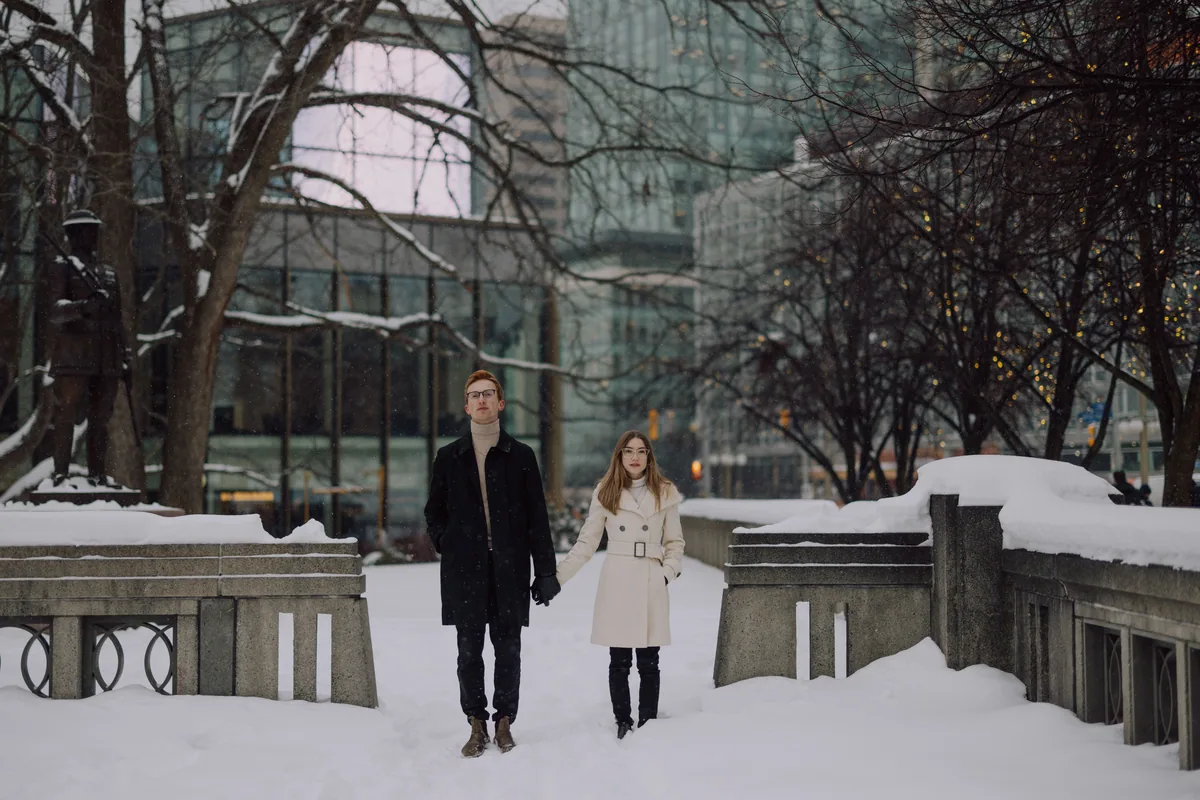 Kaitlyn and Alex during their engagement shoot on the frozen canal