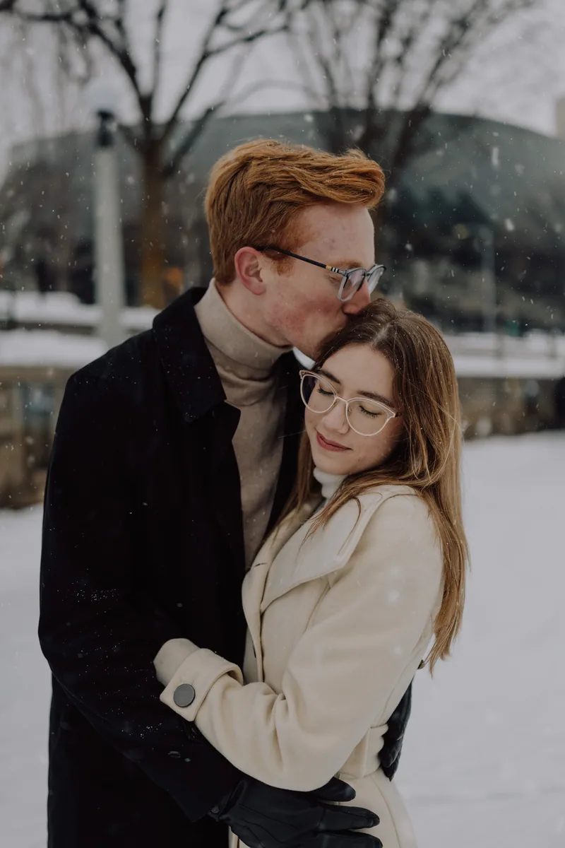 Kaitlyn and Alex during their engagement shoot on the frozen canal